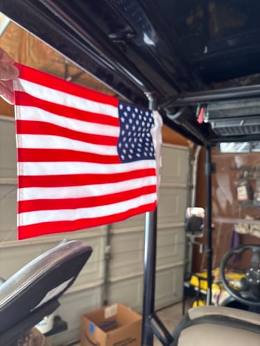American flag attached to the roll bar inside an off-road vehicle.