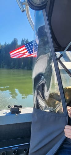 Customer's American Flag flying from the side of a boat on a sunny day.